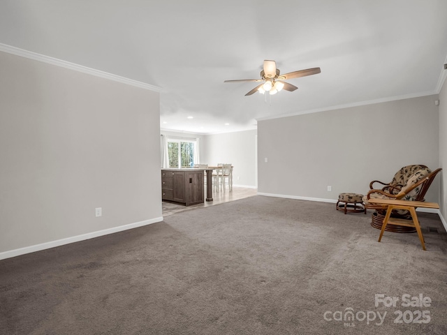unfurnished room with baseboards, carpet flooring, crown molding, and a ceiling fan
