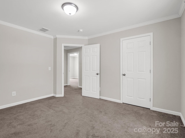 unfurnished bedroom with baseboards, carpet flooring, and crown molding