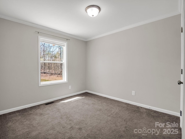 spare room featuring baseboards, carpet, visible vents, and ornamental molding