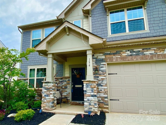 154 Rooster Tail Ln, Troutman, NC 28166 - property entrance with stone siding and a garage