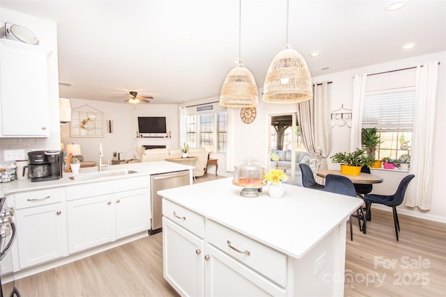 154 Rooster Tail Ln, Troutman, NC 28166 - kitchen featuring a sink, dishwasher, light wood-type flooring, a ceiling fan, and open floor plan