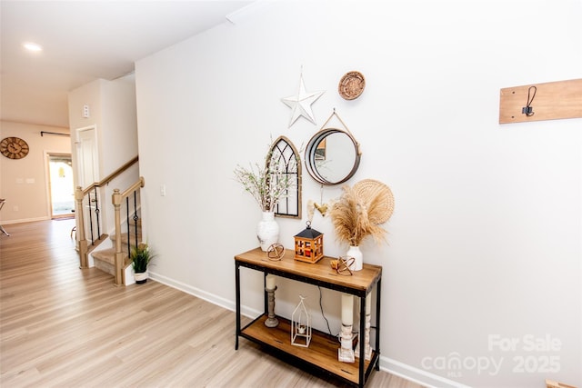 154 Rooster Tail Ln, Troutman, NC 28166 - hallway with stairway, light wood-style flooring, and baseboards