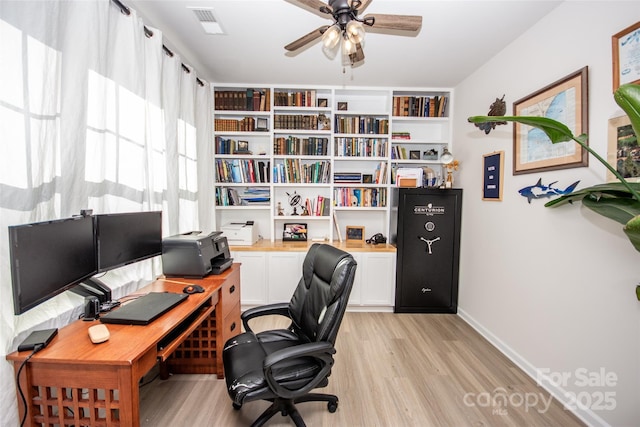 154 Rooster Tail Ln, Troutman, NC 28166 - home office featuring light wood finished floors, ceiling fan, and baseboards