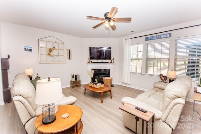 154 Rooster Tail Ln, Troutman, NC 28166 - living room with ceiling fan, light wood finished floors, and baseboards