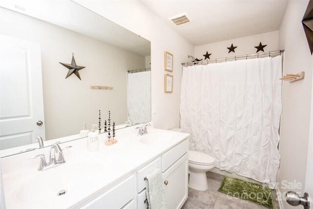 154 Rooster Tail Ln, Troutman, NC 28166 - bathroom featuring toilet, double vanity, and tile patterned floors