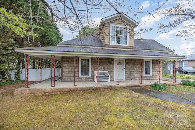 128 Allenton St, Norwood, NC 28128 - farmhouse featuring roof with shingles, fence, and a front lawn