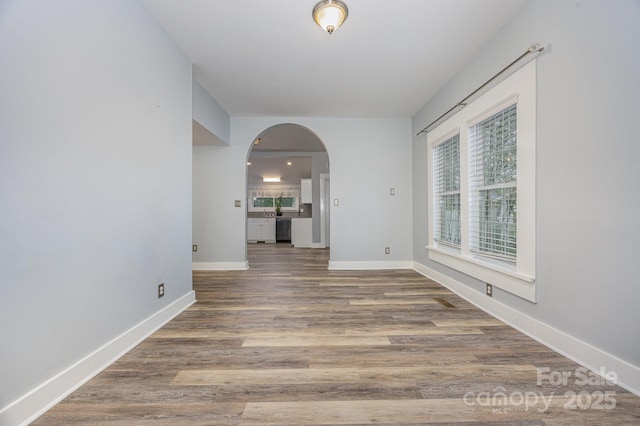 128 Allenton St, Norwood, NC 28128 - unfurnished room featuring baseboards, arched walkways, and wood finished floors