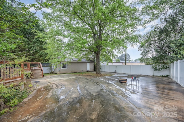 128 Allenton St, Norwood, NC 28128 - view of patio with a fire pit, a fenced backyard, a deck, and an outdoor structure