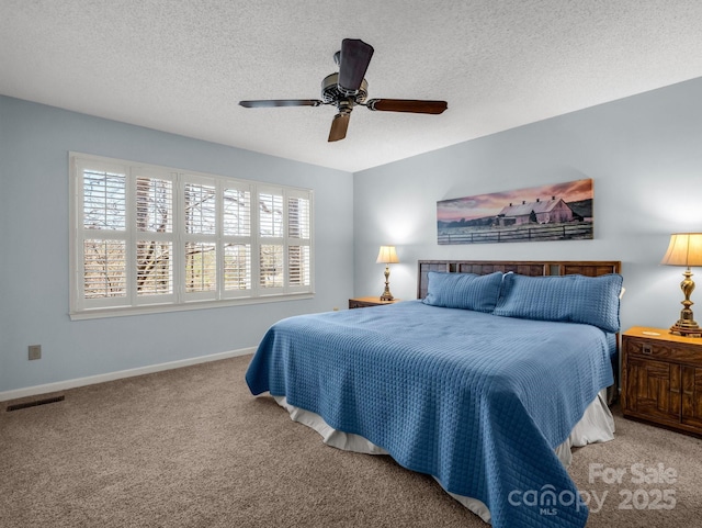 carpeted bedroom featuring visible vents, baseboards, multiple windows, and a textured ceiling