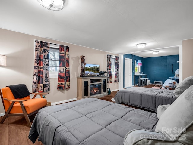 bedroom with baseboards and wood finished floors