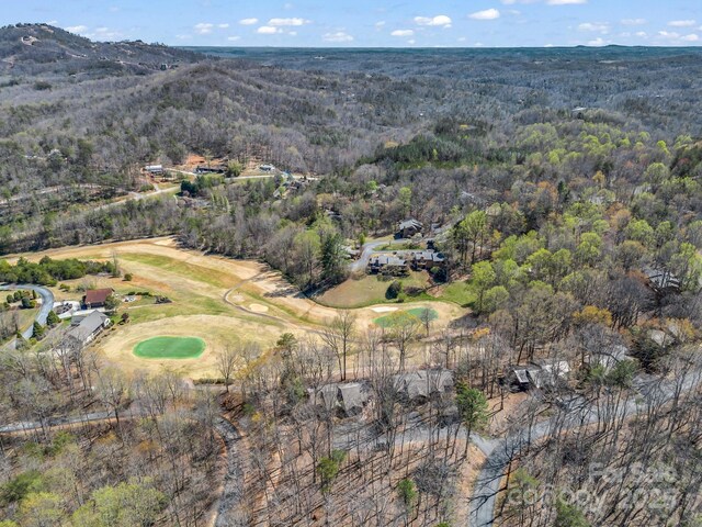 birds eye view of property featuring a forest view