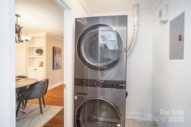842 E Woodlawn Rd, Charlotte, NC 28209 - laundry area with stacked washer and dryer, electric panel, wood finished floors, laundry area, and ornamental molding