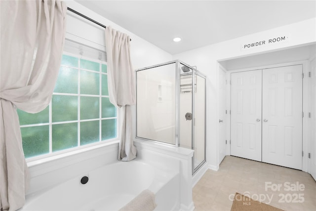 20827 Brinkley St, Cornelius, NC 28031 - full bath featuring a bath, a shower stall, tile patterned floors, and a closet