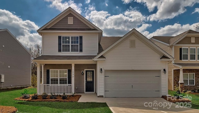 craftsman-style home with covered porch, a garage, and concrete driveway