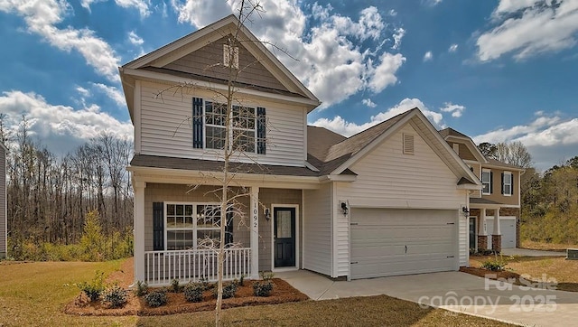 traditional home with covered porch and concrete driveway