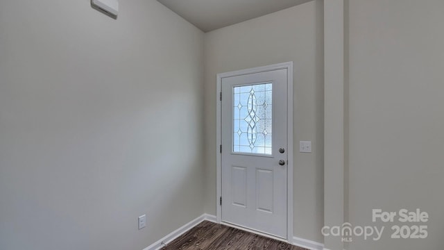 foyer with baseboards and dark wood-style floors
