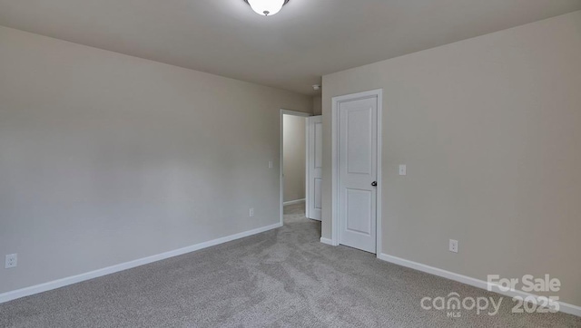 empty room with baseboards and carpet