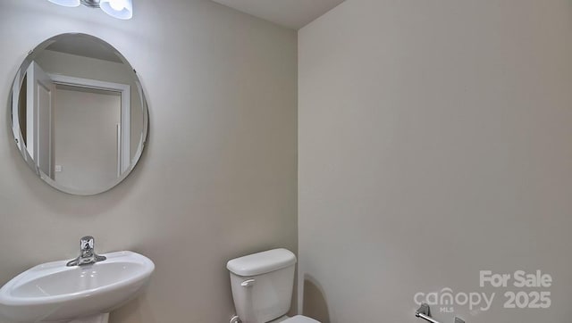 bathroom featuring toilet and a sink