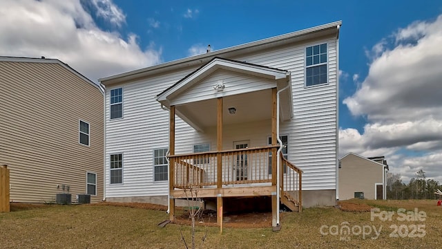 back of house featuring a yard, central air condition unit, and a deck