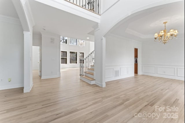 15009 Lisha Ln, Charlotte, NC 28277 - interior space featuring a notable chandelier, crown molding, arched walkways, and stairs