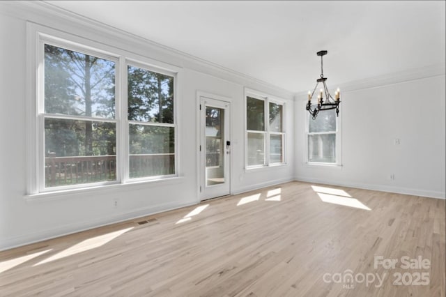 15009 Lisha Ln, Charlotte, NC 28277 - unfurnished dining area with crown molding, baseboards, light wood-style floors, visible vents, and a notable chandelier