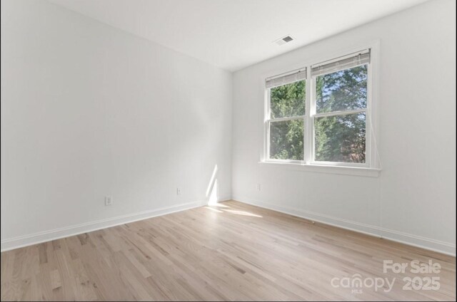 15009 Lisha Ln, Charlotte, NC 28277 - spare room featuring baseboards, light wood finished floors, and visible vents