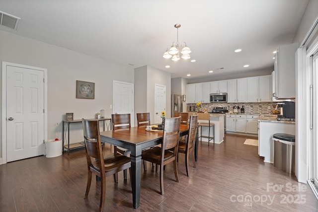 dining room with dark wood-type flooring, visible vents, a chandelier, and recessed lighting