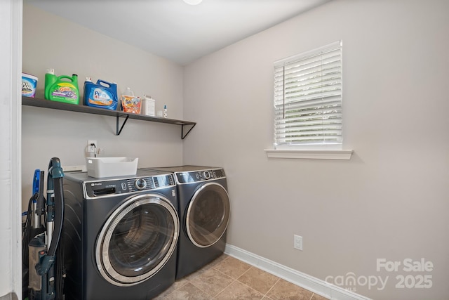 washroom featuring baseboards, washer and dryer, laundry area, and tile patterned floors