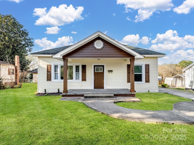 bungalow featuring a front lawn and covered porch