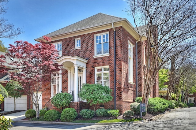 view of front of property with brick siding and a shingled roof