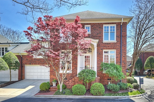 view of front of property featuring brick siding, driveway, a garage, and a shingled roof