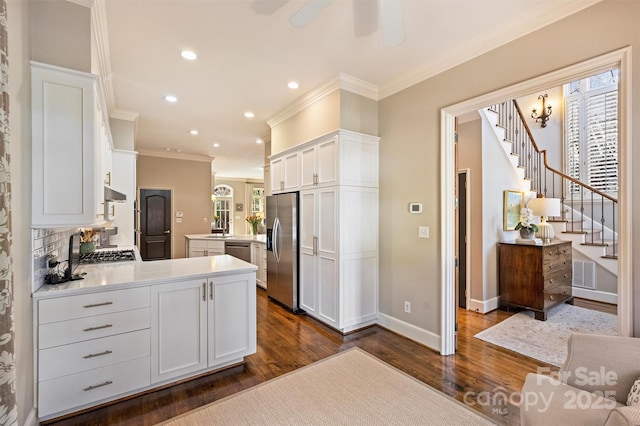 kitchen with stainless steel fridge with ice dispenser, white cabinetry, a peninsula, visible vents, and dark wood-style flooring
