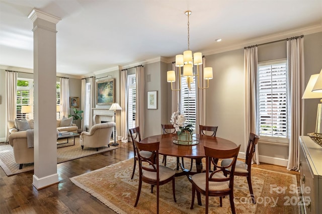 dining room featuring baseboards, decorative columns, ornamental molding, and dark wood-style flooring