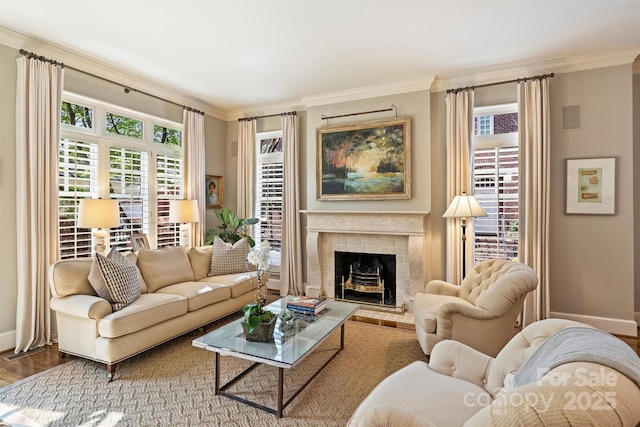 living room featuring a wealth of natural light, wood finished floors, baseboards, and ornamental molding