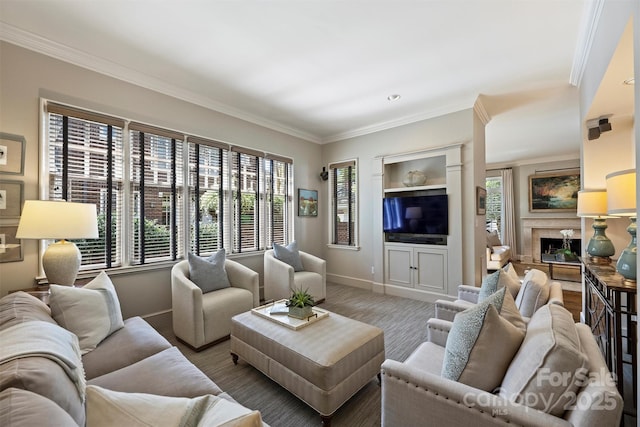 living room with baseboards, a fireplace, and crown molding