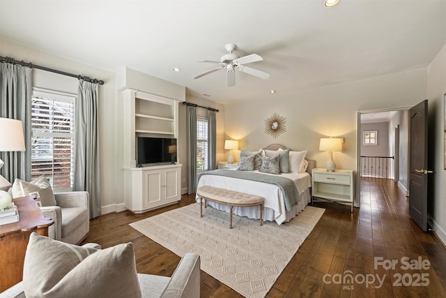 bedroom with a ceiling fan, dark wood-type flooring, baseboards, and recessed lighting