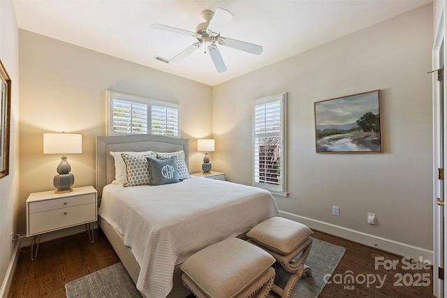 bedroom featuring wood finished floors, baseboards, ceiling fan, and visible vents
