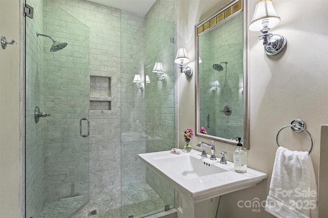 full bathroom with a sink and a shower stall