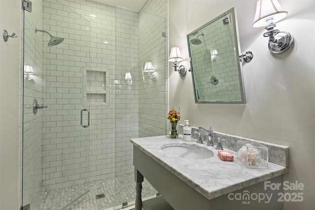 full bathroom featuring vanity and a stall shower