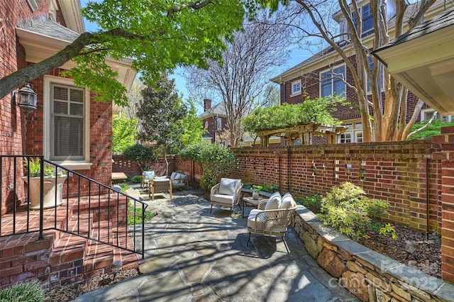 view of patio / terrace featuring an outdoor living space and fence