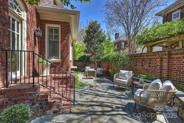 view of patio / terrace featuring fence and outdoor lounge area