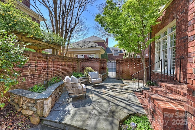 view of patio / terrace featuring a gate and fence