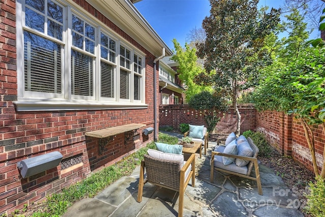 view of patio / terrace featuring an outdoor hangout area and fence