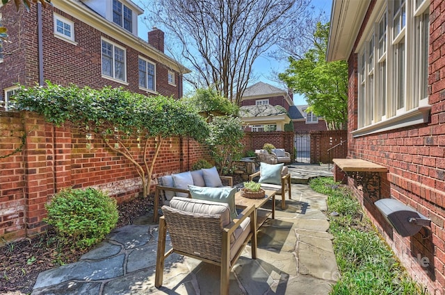 view of patio featuring an outdoor hangout area and fence