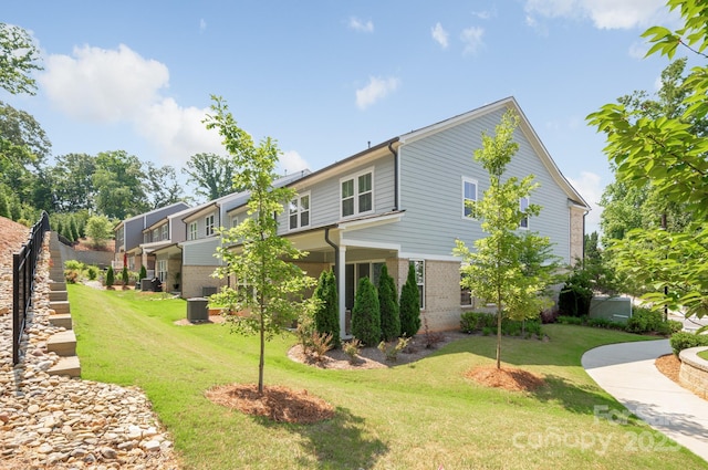 3111 Everly Enclave Way, Charlotte, NC 28210 - view of home's exterior with brick siding and a yard