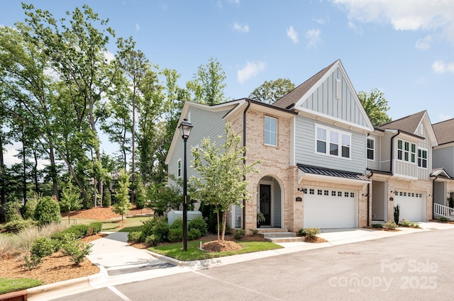 3111 Everly Enclave Way, Charlotte, NC 28210 - townhome / multi-family property with board and batten siding, brick siding, a garage, concrete driveway, and a standing seam roof