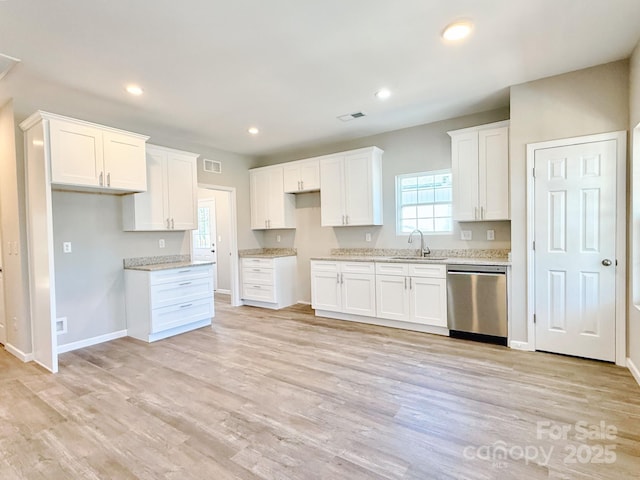 kitchen with recessed lighting, a sink, light wood-style floors, dishwasher, and white cabinets