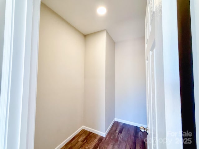 interior space featuring baseboards and dark wood finished floors