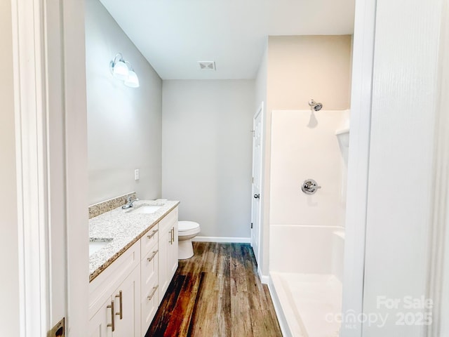 full bath featuring a shower, toilet, a sink, visible vents, and wood finished floors