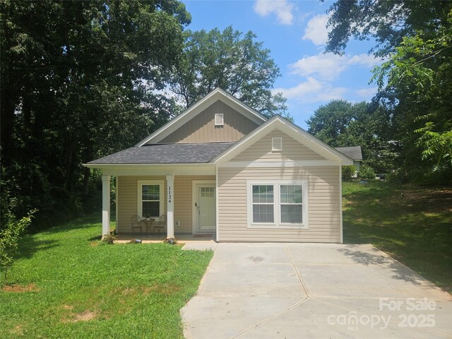 1124 Clouse St, Gastonia, NC 28052 - bungalow-style house featuring covered porch, a front lawn, driveway, board and batten siding, and a shingled roof